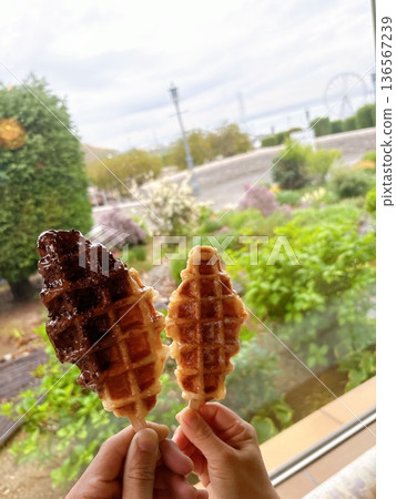 Eating on the go: Chocolate and plain waffles 136567239