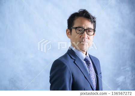 A cool-looking man wearing glasses like a business executive, looking at the camera A cool-looking man wearing glasses like a business executive, looking at the camera 136567272