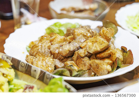 A serving of bite-sized sauteed pork 136567300