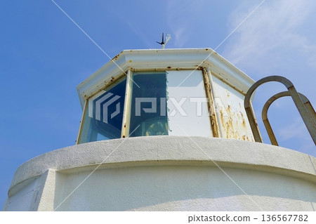 A view of the Anorizaki Lighthouse and the surrounding area. The top of the lighthouse and the sky. Ago-cho, Shima City, Mie Prefecture. A view of the Anorizaki Lighthouse and the surrounding area. The top of the lighthouse and the sky. Ago-cho, Shima City, Mie Prefecture. 136567782
