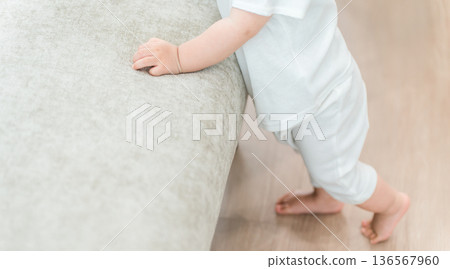 Baby standing up using a chair Baby standing up using a chair 136567960