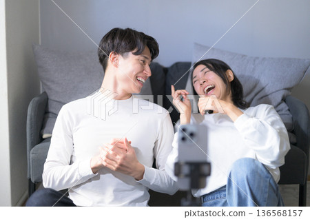 Men and women streaming videos at home Men and women streaming videos at home 136568157