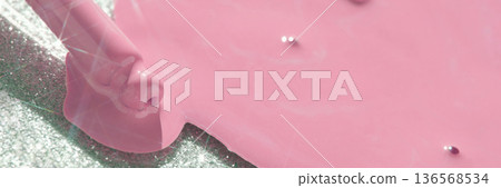 Close-up of pink nail polish spill on glitter surface with brush 136568534