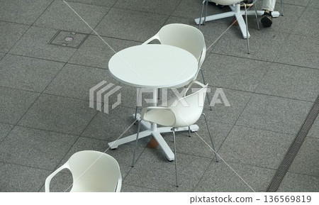 Bird's-eye view of the terrace: white table and chairs 136569819
