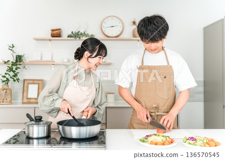 一對年輕的亞洲夫婦在廚房做飯 一對年輕的亞洲夫婦在廚房做飯 136570545