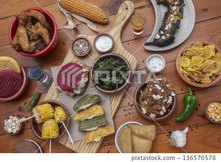 mixed colombian and venezuelan food meal spread on wooden restaurant table mixed colombian and venezuelan food meal spread on wooden restaurant table 136570578