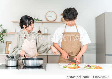 Cooking in the kitchen, young Asian couple cooking, couple (angry, emotional abuse, complaining, hysterical) Cooking in the kitchen, young Asian couple cooking, couple (angry, emotional abuse, complaining, hysterical) 136570828