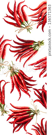 Bunches of red chili peppers with green leaves isolated  on white background, concept of spice and flavor 136571363