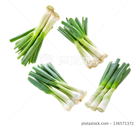 Multiple fresh green leek bunches isolated on white background, representing organic vegetables concept 136571372