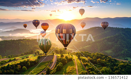 Hot Air Balloons Flying Over Scenic Landscape at Sunrise Hot Air Balloons Flying Over Scenic Landscape at Sunrise 136571412
