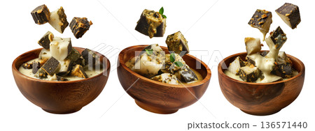Steamed taro and rice cakes with coconut sauce, scallions, and peanuts in wooden bowl, isolated on white background Steamed taro and rice cakes with coconut sauce, scallions, and peanuts in wooden bowl, isolated on white background 136571440