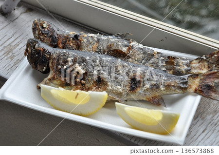 Catch rainbow trout from a fishing pond and grill it on the spot Catch rainbow trout from a fishing pond and grill it on the spot 136573868