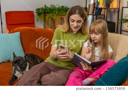 Mother daughter dog learn math on smartphone tutorial explain write notes solve task hooray gesture Mother daughter dog learn math on smartphone tutorial explain write notes solve task hooray gesture 136573959
