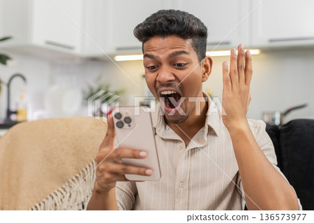 Indian man watches wow video reacts with shock eyes laughs shares link to friends in messenger chat Indian man watches wow video reacts with shock eyes laughs shares link to friends in messenger chat 136573977