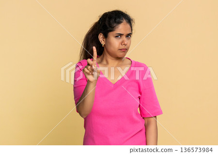 Indian woman shaking finger and head disapprovingly, showing clear no warning to camera Indian woman shaking finger and head disapprovingly, showing clear no warning to camera 136573984