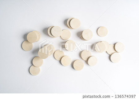 some rough wooden discs scattered 136574397