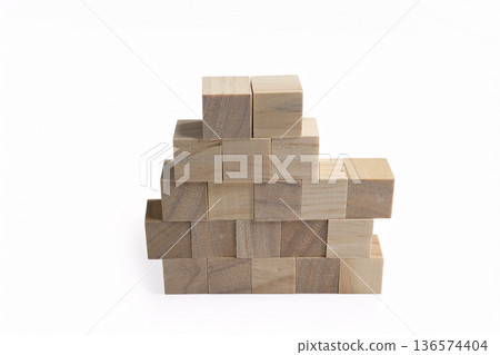 a neat stack of rough wooden cubes 136574404