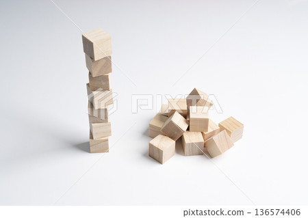 a neat pile of rough wooden cubes and a messy pile a neat pile of rough wooden cubes and a messy pile 136574406