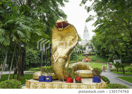 The white pagoda and cobra statue of Wat Phnom on the hill The white pagoda and cobra statue of Wat Phnom on the hill 136574768