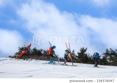 滑雪者們正在為滑雪比賽設定路線 滑雪者們正在為滑雪比賽設定路線 136576047