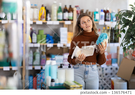 Young woman choosing body washcloth in store Young woman choosing body washcloth in store 136576471