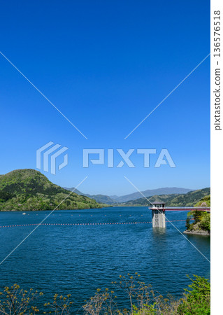 Shichikashuku Dam and Lake with blue sky and fresh greenery 136576518