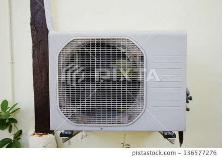 Air outdoor conditioning compressor on concrete wall Air outdoor conditioning compressor on concrete wall 136577276