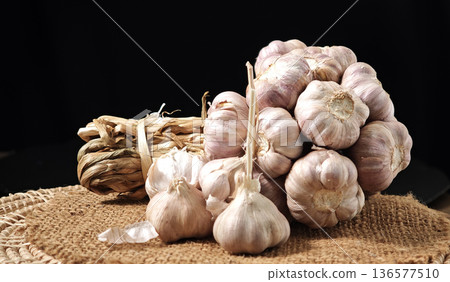 Garlic herb in a basket on a wooden table. 136577510