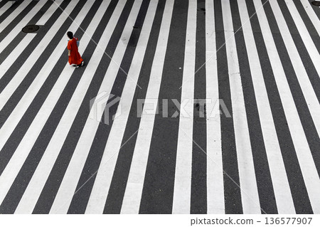 Summer crosswalk, a woman in red clothes crossing alone - 2 136577907