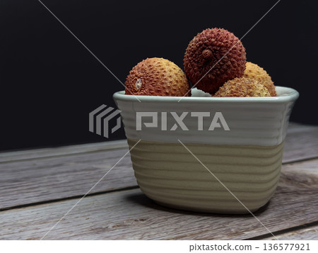Lychee Fruit in Ceramic Bowl on Wooden Table with Copy Space Lychee Fruit in Ceramic Bowl on Wooden Table with Copy Space 136577921