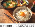 Breakfast of rice with a raw egg on top and miso soup 136578135