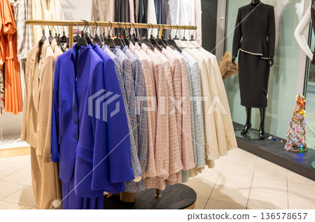 Elegant women's blazers collection in boutique display Elegant women's blazers collection in boutique display 136578657