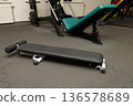 Gym equipment with bench press and workout machines in fitness center 136578689