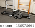 Gym equipment featuring weight bench and exercise accessories in fitness center 136578691
