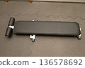 Flat workout bench on carpeted gym floor in fitness center 136578692