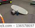 Balance board with foam roller and water bottle in gym setting 136578697