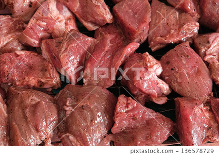 Raw sliced pork in sauce. Pieces of fresh marinated pork medallions. Freshly meat tenderloin, perfect for culinary, home cooked meals and flavor. Chopped Pork ham fillet with spice, herbs. 4K video 136578729