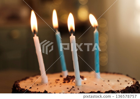 Child Celebrating Birthday Party at Home. Cheerful Girl's Little kid Birthday Celebration. Adult preparing a festive cake, cutting pieces, lights up burning candles. Surprise. Children birth. Low key 136578757