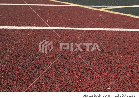 Sport floor. Interior of empty modern indoor sport court, coating Crumb rubber flooring, artificial. Sports surface with different marking lines. Recycled rubber Athletic field. Run track markup. 4K Sport floor. Interior of empty modern indoor sport court, coating Crumb rubber flooring, artificial. Sports surface with different marking lines. Recycled rubber Athletic field. Run track markup. 4K 136579135