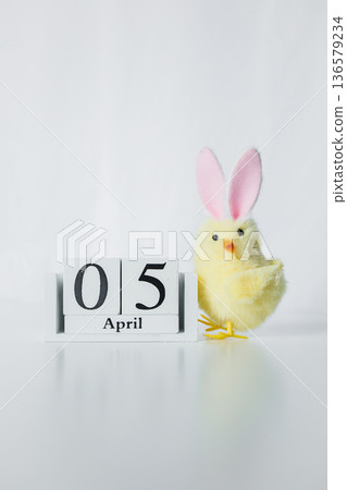 Christian Catholic Easter 2026 date on a wooden calendar with funny small Easter chick toy on white background Christian Catholic Easter 2026 date on a wooden calendar with funny small Easter chick toy on white background 136579234