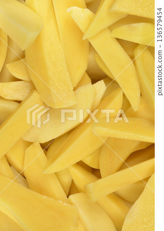Peeled and Sliced Raw Yellow Potatoes Peeled and Sliced Raw Yellow Potatoes 136579454