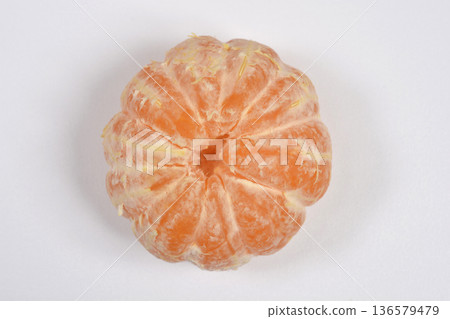 Peeled whole tangerine on white background 136579479