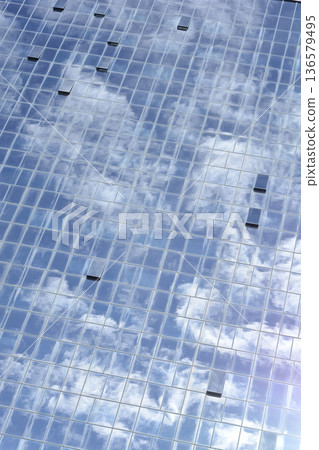 Glass Building Facade with Clouds Reflection Glass Building Facade with Clouds Reflection 136579495