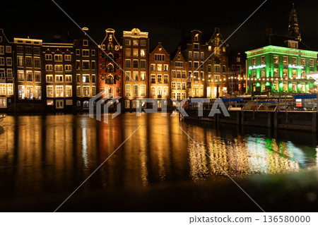 Amsterdam city at night. Old water canal houses in Netherlands 136580000
