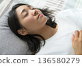 Sleeping face of a Japanese woman sleeping in bed 136580279