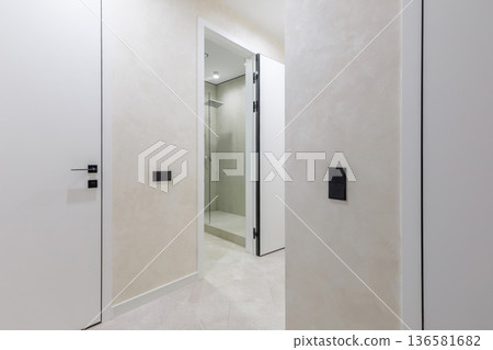 Modern Apartment Hallway with Open Bathroom Door and Minimalist Decor 136581682