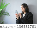 Japanese woman using a smartphone at home 136581761