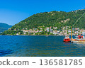 Como lake water in Summer day. Multicolor houses on green mountains Italian travel. Italy 136581785