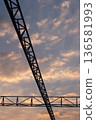 Beautiful sunset sky with cloud, with silhouette of structural truss on the foreground 136581993