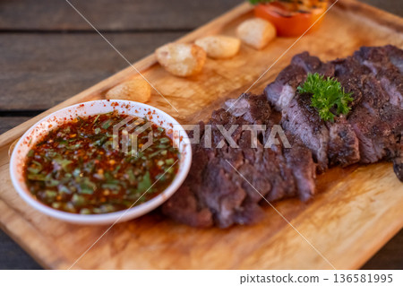 Medium rare meat steak served on plate 136581995